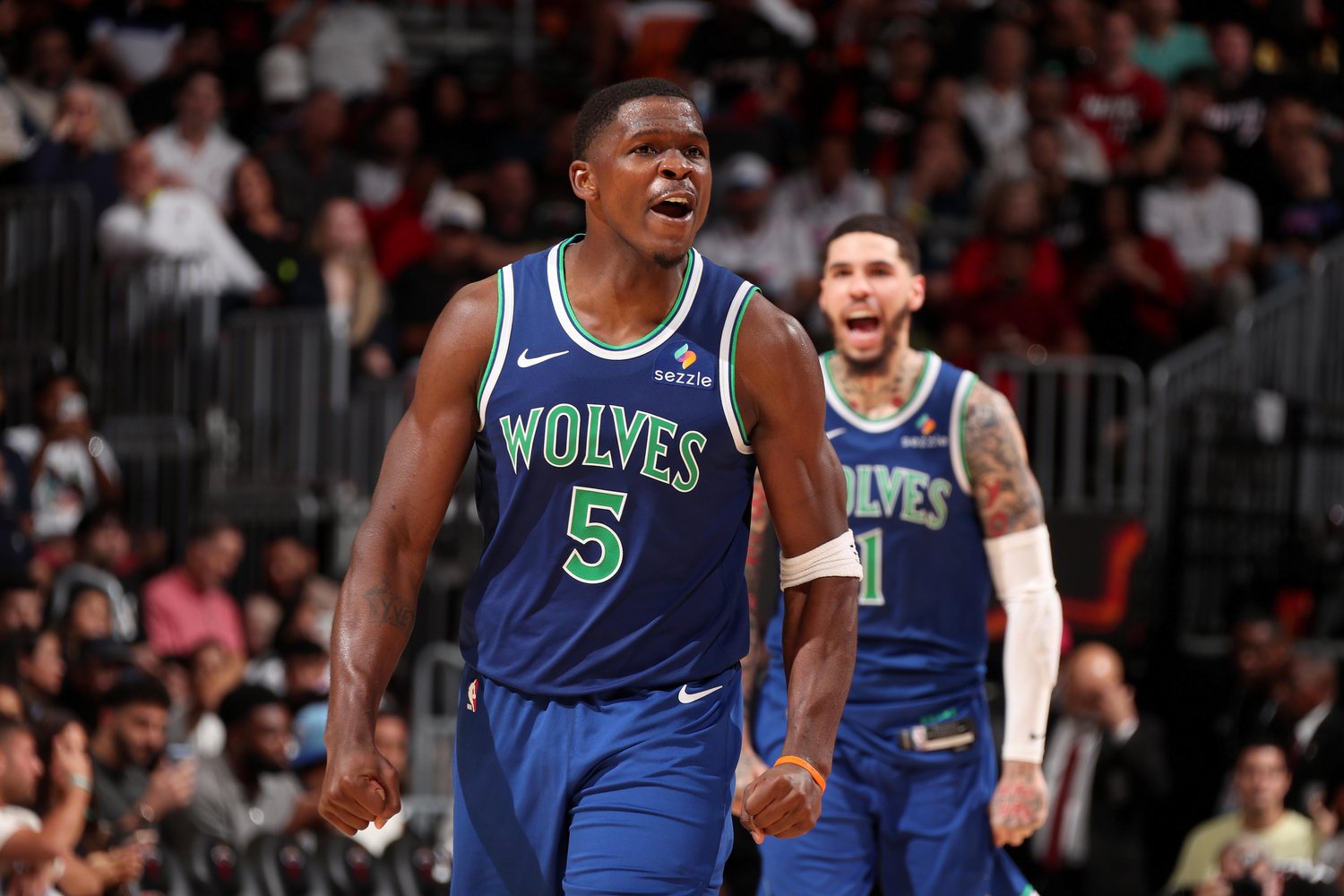 Anthony Edwards in a blue Wolves jersey with LaMelo Ball behind him.