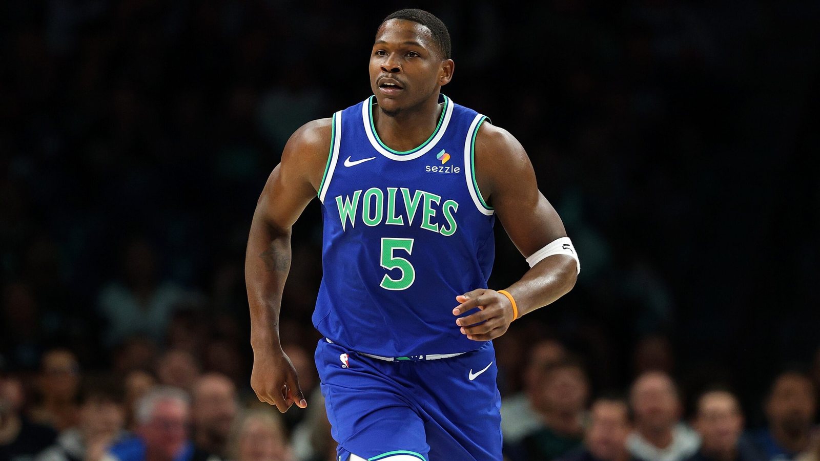 Anthony Edwards on the court in a blue Timberwolves uniform.