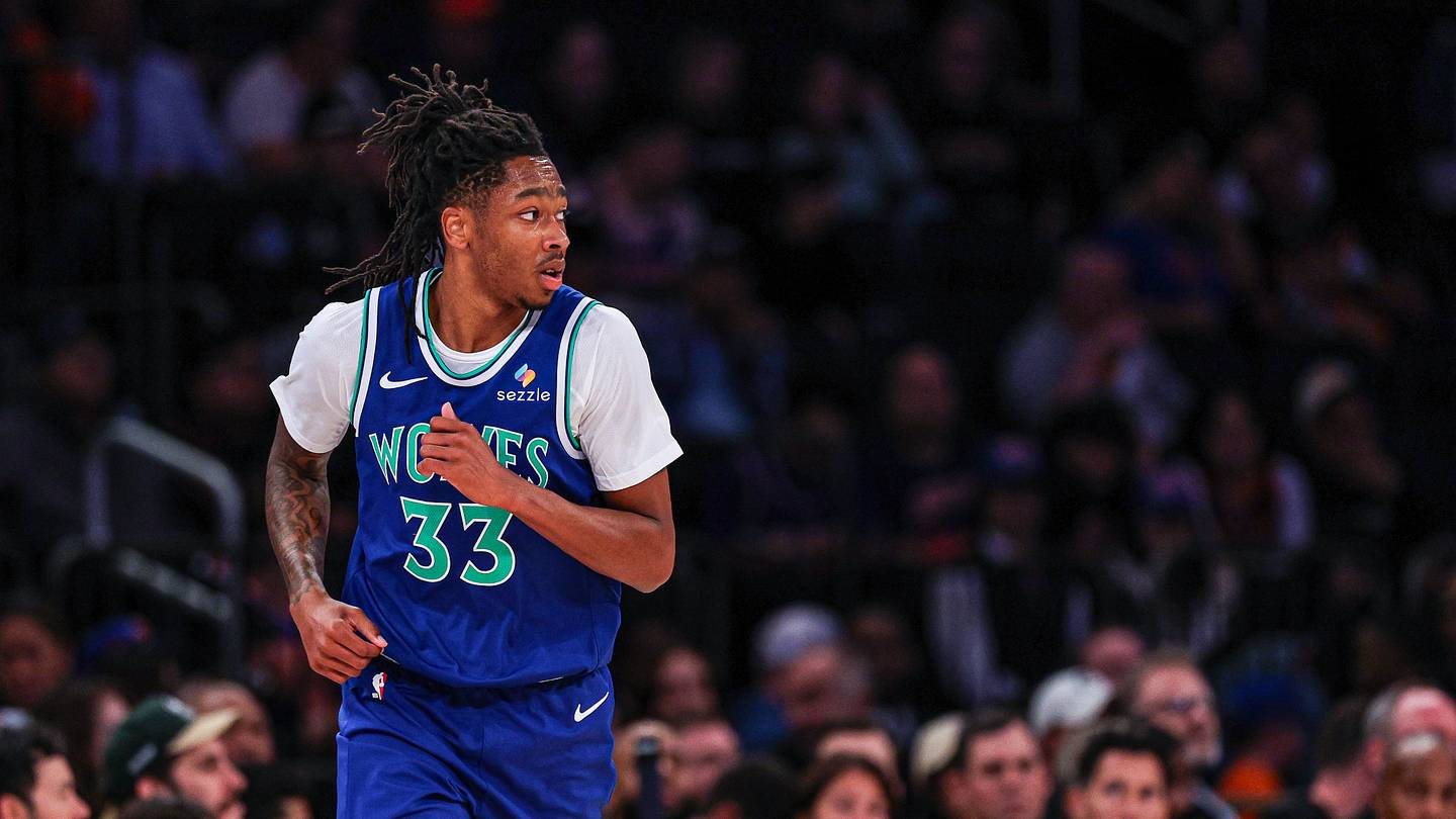 Isaiah Evans in a Timberwolves No. 33 jersey runs back up the floor during a preseason game.