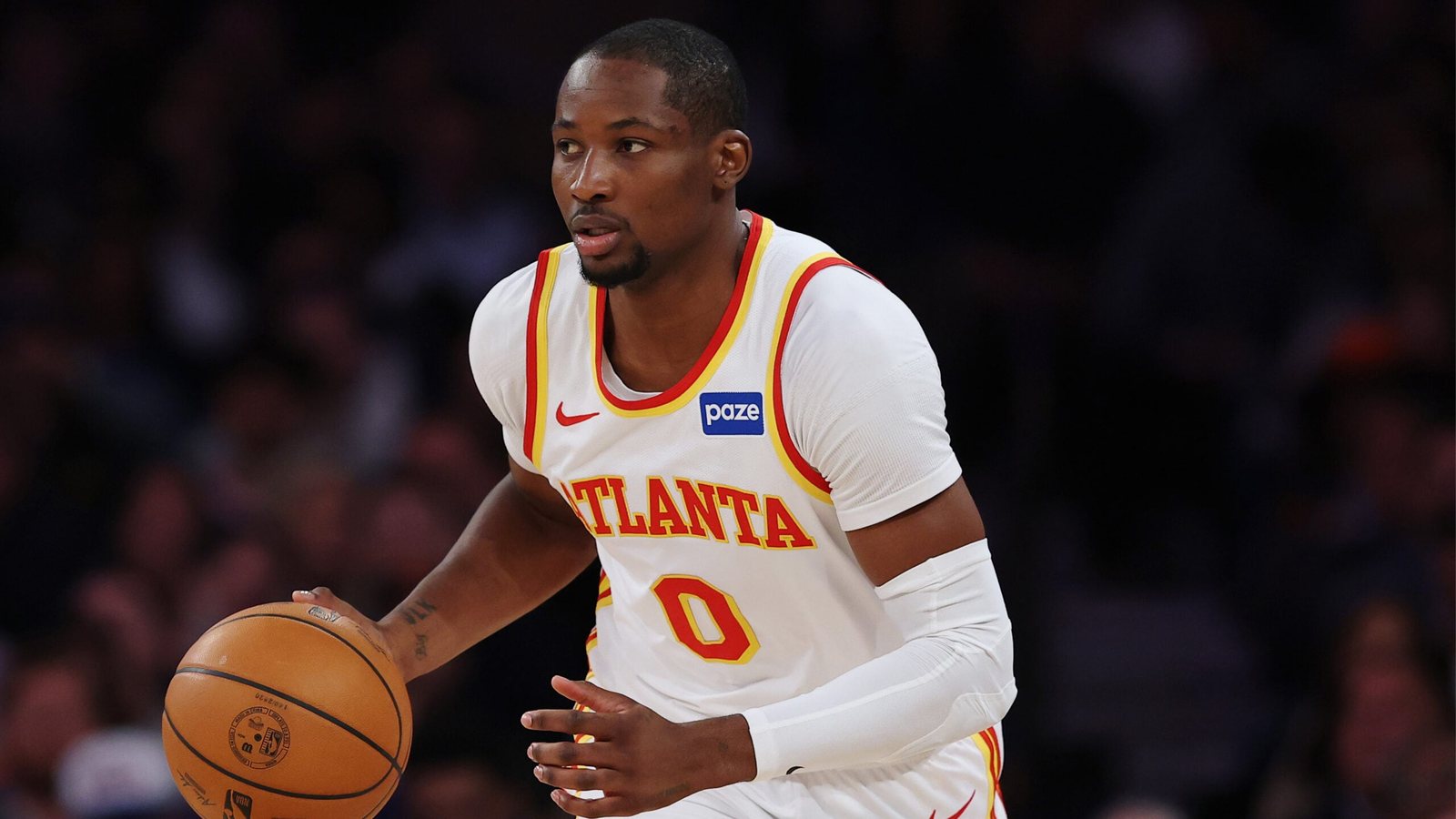 Jonathan Kuminga dribbles up the floor in a white Atlanta Hawks uniform.