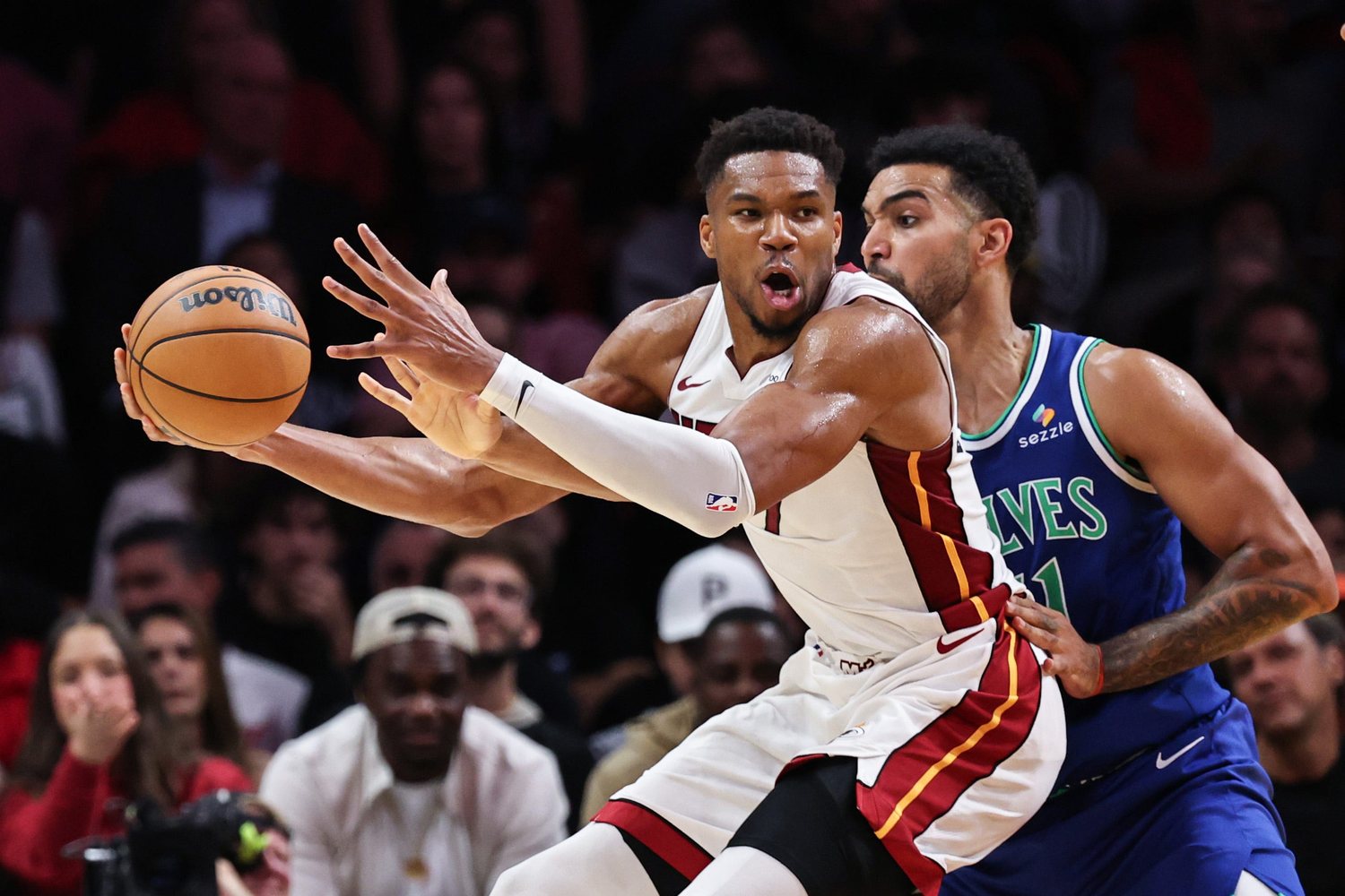 Rudy Gobert defends Giannis Antetokounmpo, who holds the ball in a white Miami uniform.