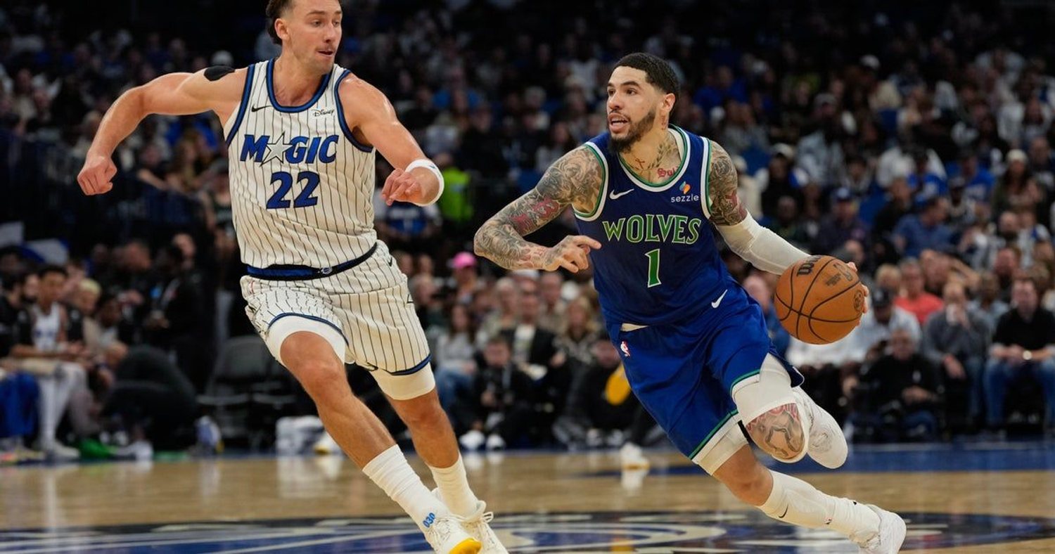 LaMelo Ball dribbles in a blue Wolves uniform beside Orlando's Franz Wagner.