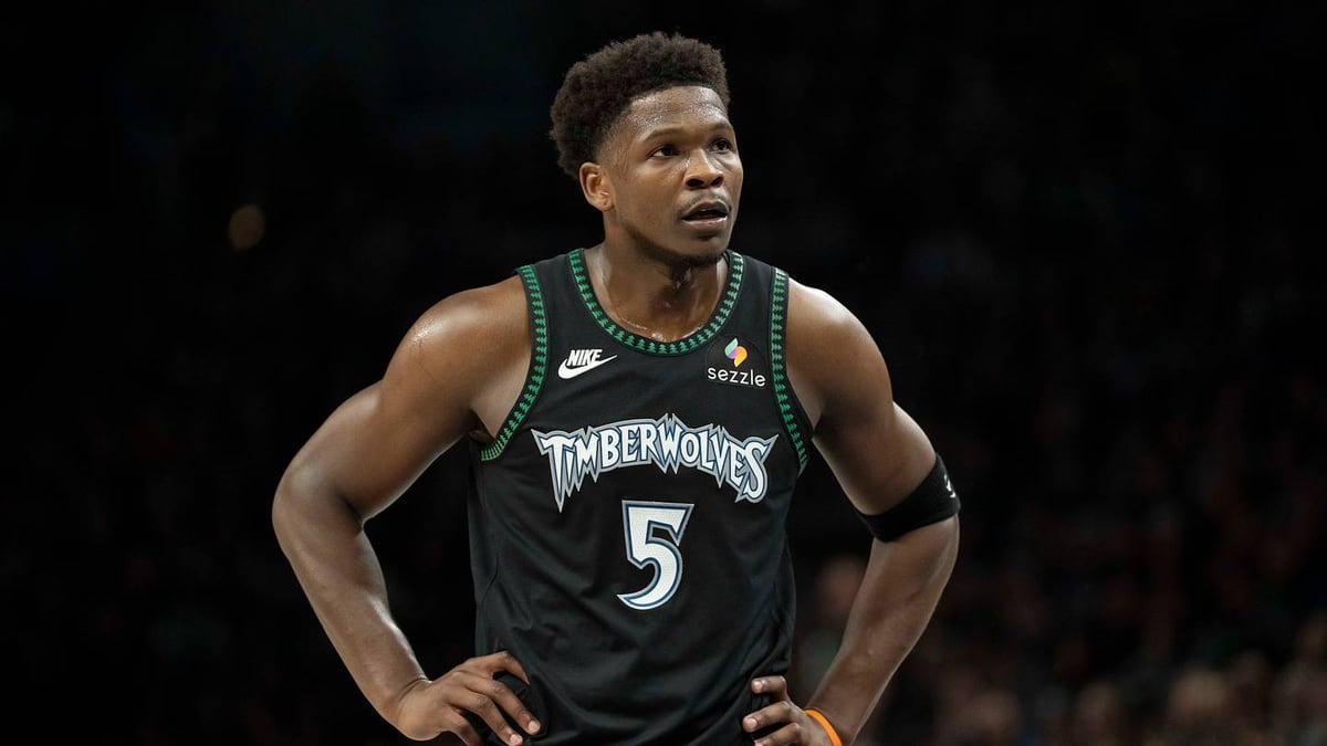 Anthony Edwards standing with his hands on his hips during a Timberwolves game.