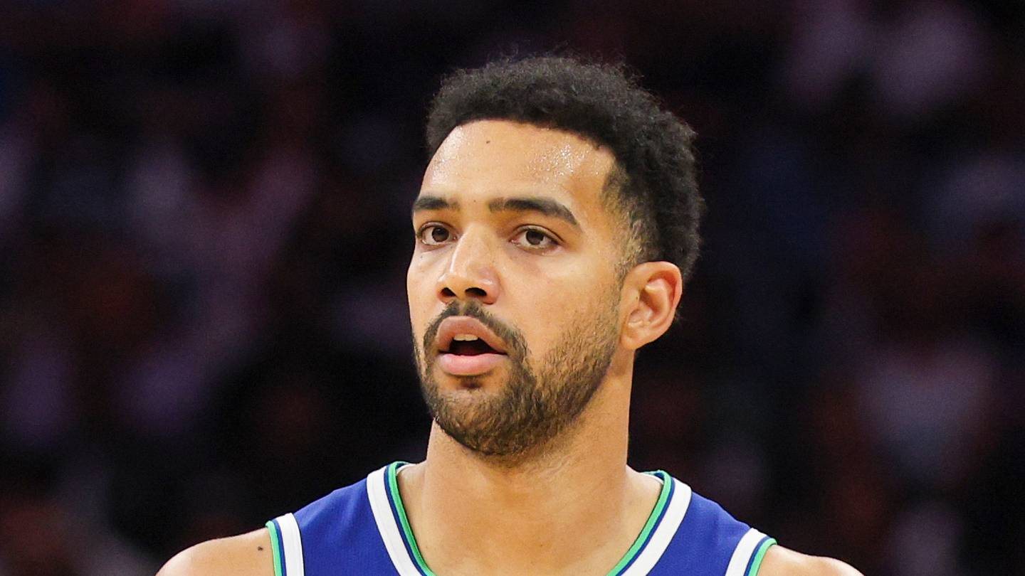 Trey Lyles looks across the court in a blue Timberwolves uniform.
